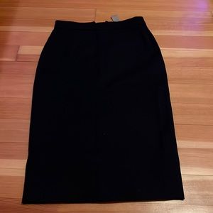 Black long skirt. Slit in back. Zipper on back of skirt